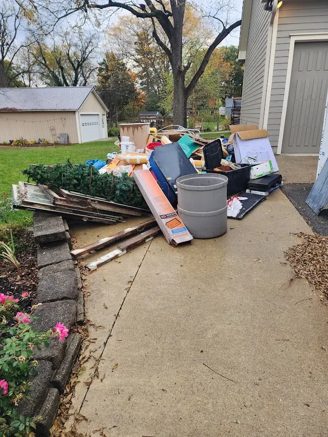 Dumpster being loaded with debris for Roofing Dumpster Rental in Walnut Ridge